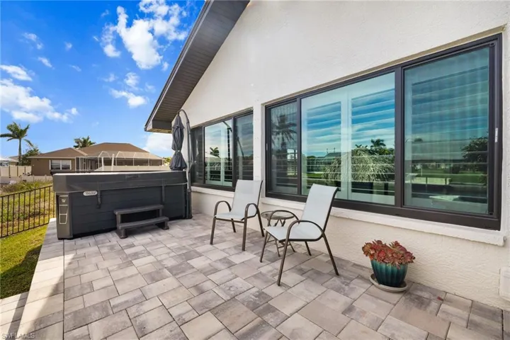 View of patio / terrace with fence and a hot tub