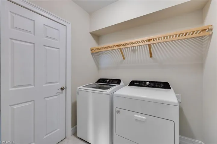 Laundry UPSTAIRS! area featuring baseboards and washer and clothes dryer