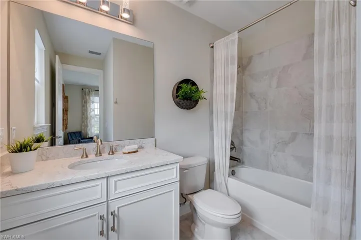 Downstairs Ensuite bathroom with shower / tub combo and vanity
