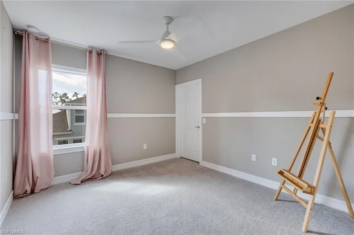 Bedroom #2 featuring light carpet and a ceiling fan