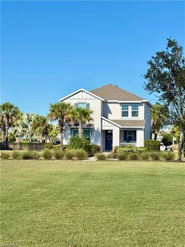 View of front facade featuring stucco siding and a shingled roof