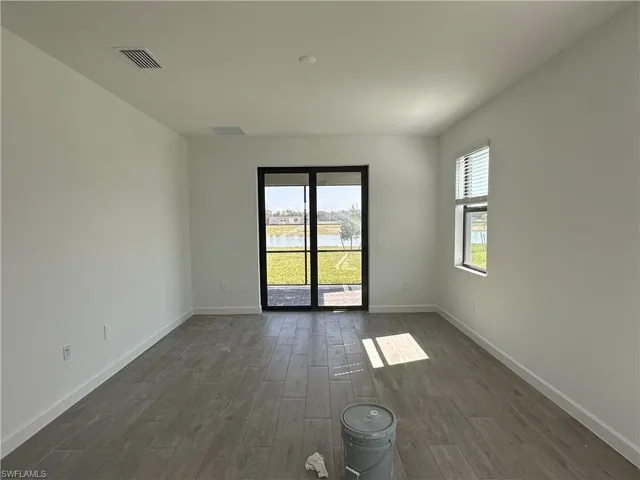 Unfurnished room with dark hardwood / wood-style floors