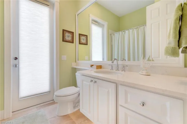 Bathroom with tile patterned flooring, vanity, and toilet