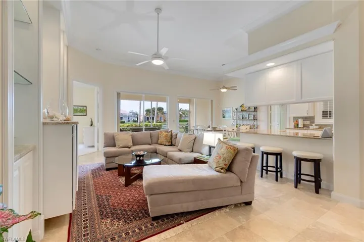 Living room with ceiling fan and crown molding