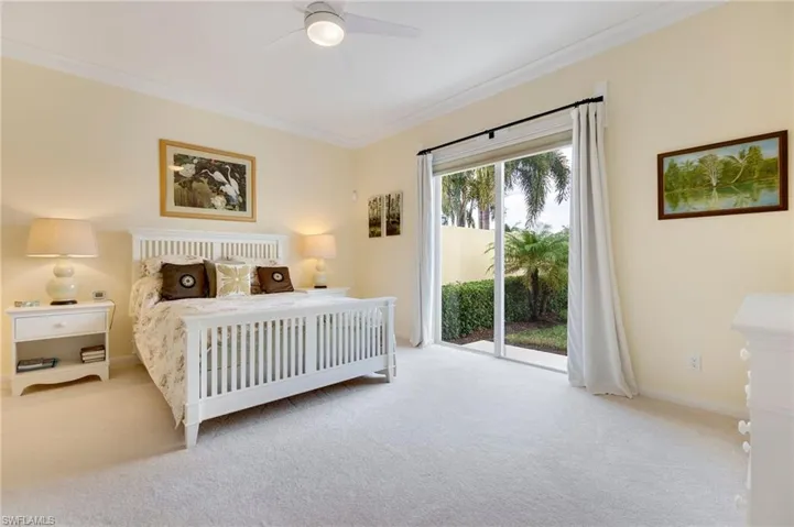 Bedroom featuring access to exterior, light colored carpet, ceiling fan, and ornamental molding