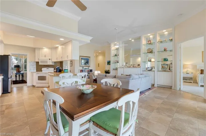 Dining area featuring ceiling fan and ornamental molding