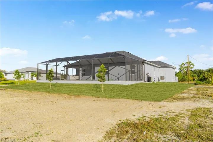 View of community featuring a sunroom and a yard
