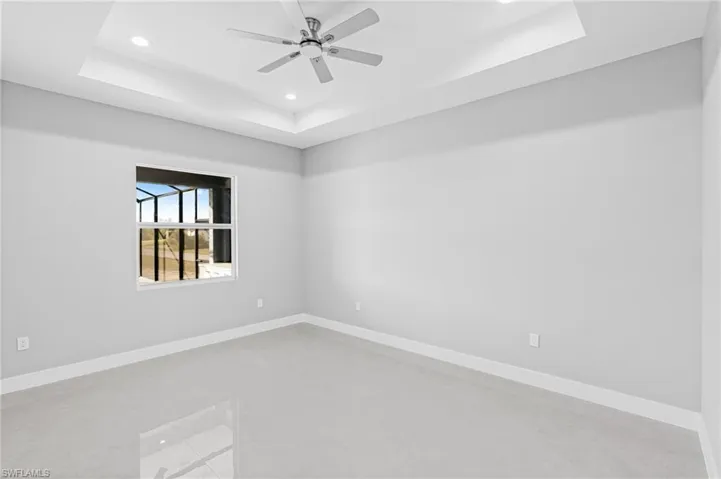 Unfurnished room with a tray ceiling, recessed lighting, and ceiling fan