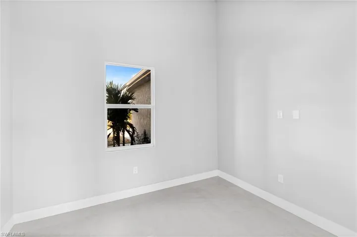 Empty room featuring baseboards