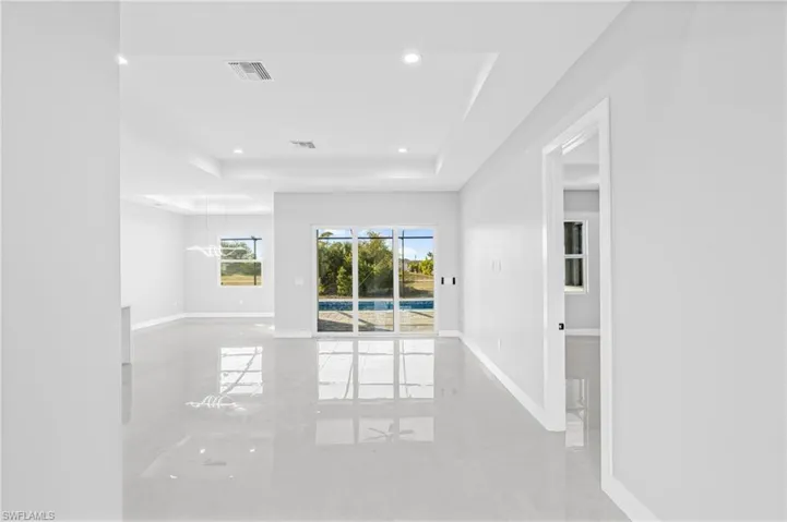 Unfurnished room featuring a raised ceiling and recessed lighting