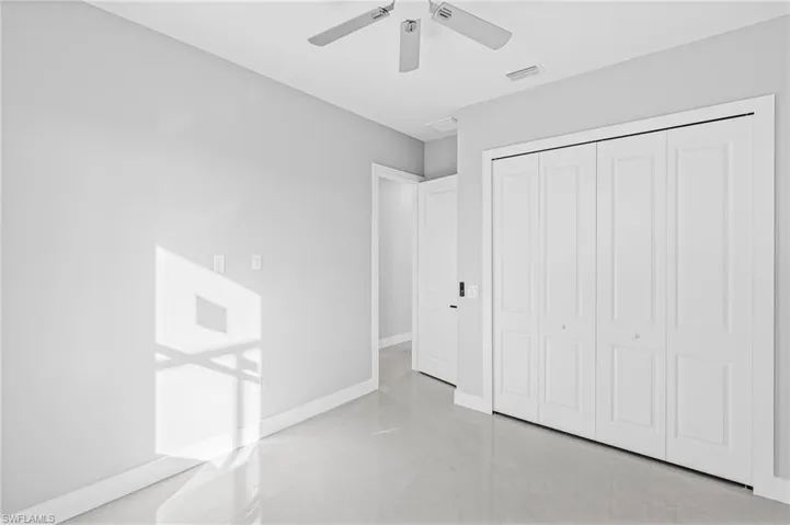 Unfurnished bedroom featuring a ceiling fan and a closet