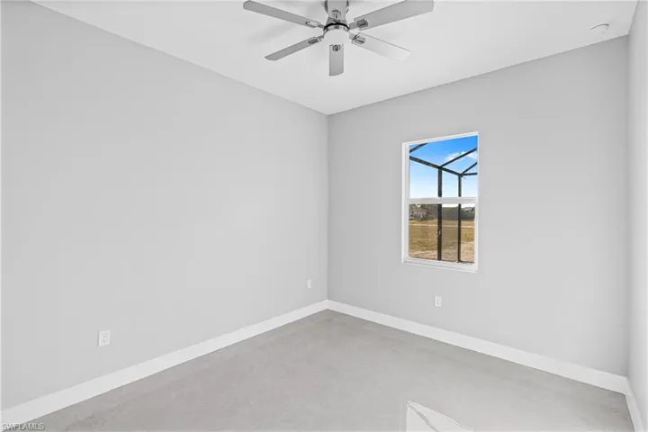 Spare room featuring concrete flooring and ceiling fan