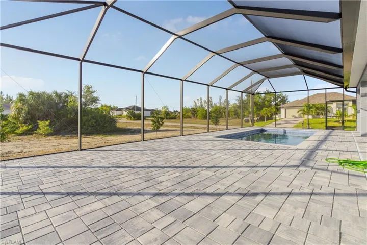 Swimming pool featuring a sunroom, a lanai, and a patio