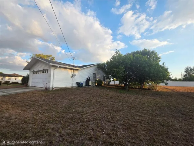 View of side of home with driveway, a garage, and a yard