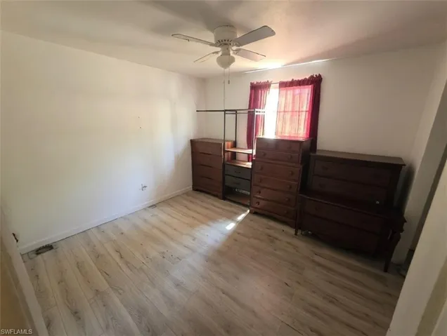 Bedroom with light wood-style floors and ceiling fan
