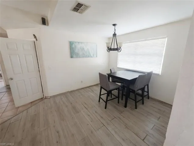 Dining area featuring hanging lights and light wood-style flooring
