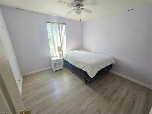 Bedroom with wood finished floors and a ceiling fan