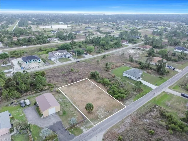 Aerial perspective of suburban area featuring property boundaries highlighted