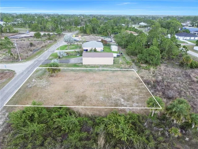 Aerial view of residential area featuring property boundaries highlighted