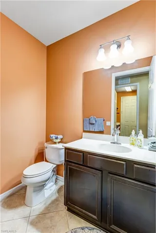 Bathroom featuring light tile patterned floors and vanity