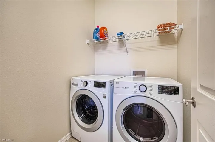 Clothes washing area featuring washer and clothes dryer