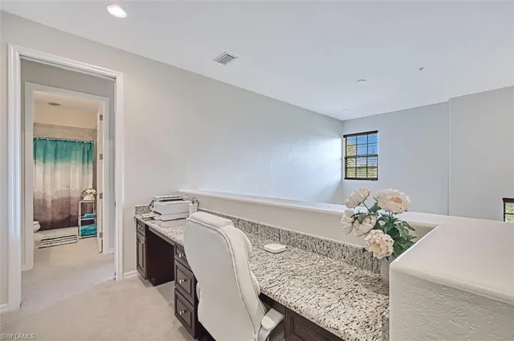 Office with light carpet and baseboards