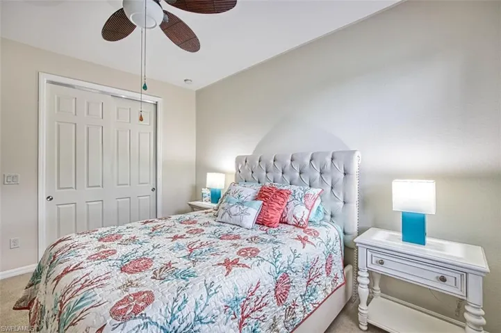 Bedroom with carpet floors, a closet, a ceiling fan, and baseboards