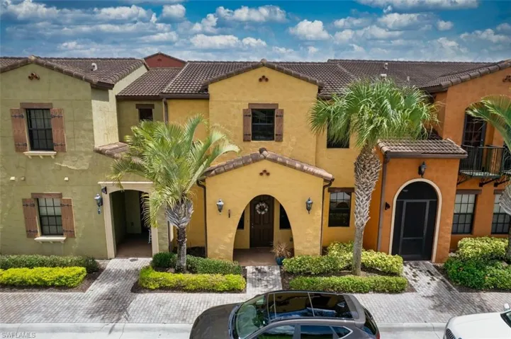 View of front of home with a tile roof and stucco siding