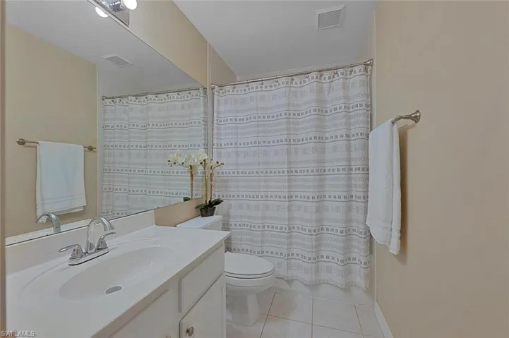 Bathroom featuring tile patterned flooring, vanity, and toilet