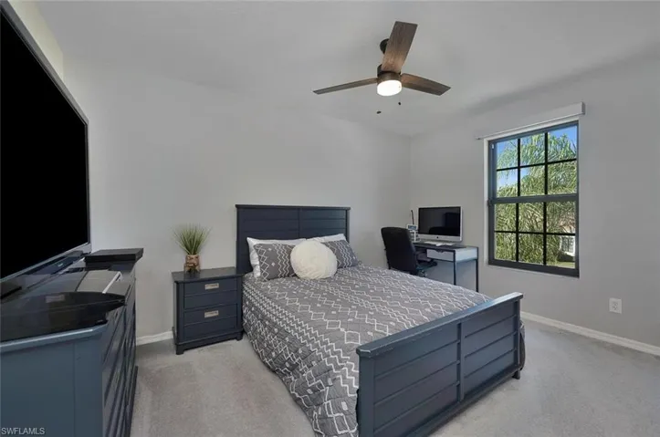 Bedroom featuring ceiling fan and light colored carpet