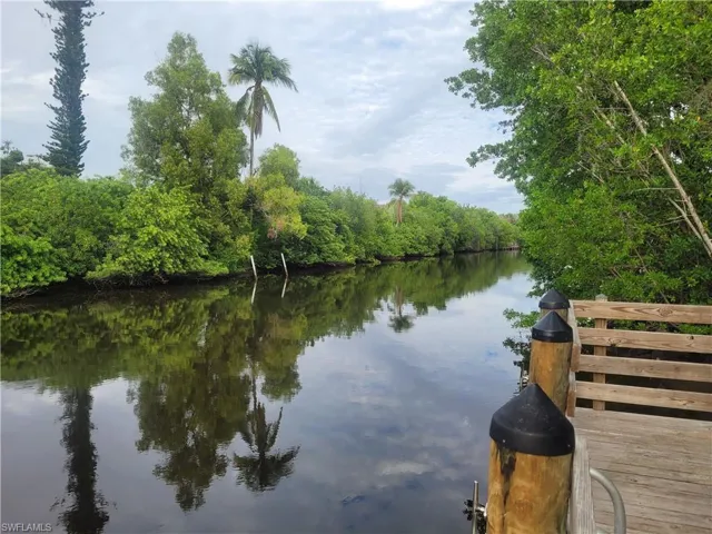 Water view with a heavily wooded area