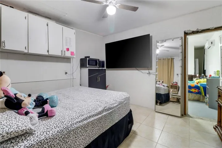 Tiled bedroom with ceiling fan