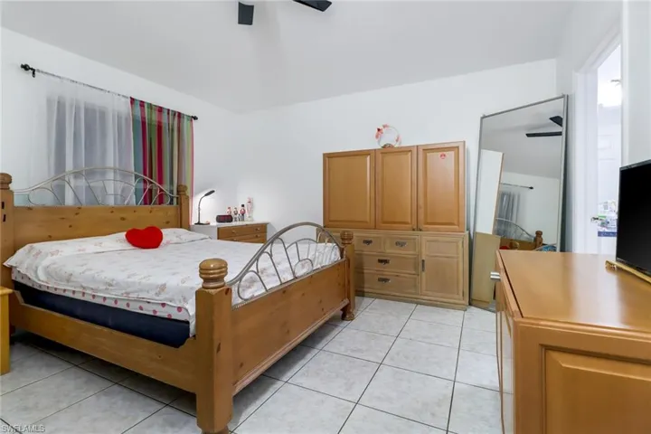 Tiled bedroom with ceiling fan