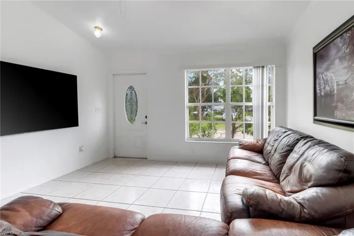 Tiled living room featuring ornamental molding