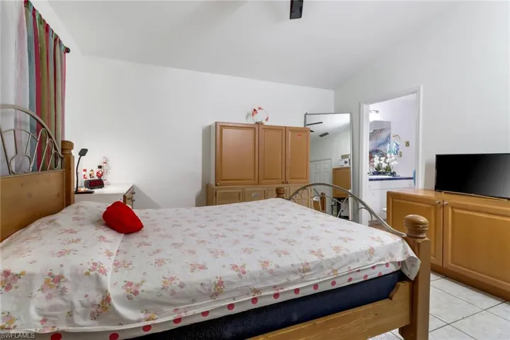 Tiled bedroom with ceiling fan