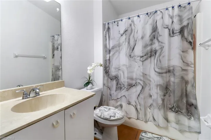 Full bathroom with vanity, toilet, tile patterned flooring, and shower / tub combo with curtain