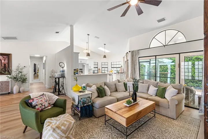 Vaulted ceilings featuring a ceiling fan and an arched transom window