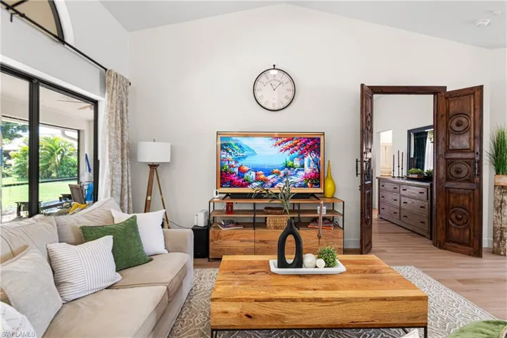 Vaulted ceiling with light wood-finish flooring