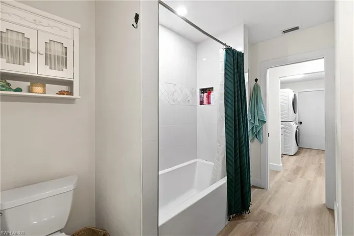 Bathroom featuring a tub/shower combination with white subway tile surround and a tiled shower niche