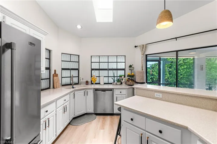 kitchen featuring bright white cabinetry, light-toned countertops, and stainless steel appliances