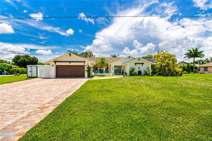 Expansive front lawn with mature landscaping