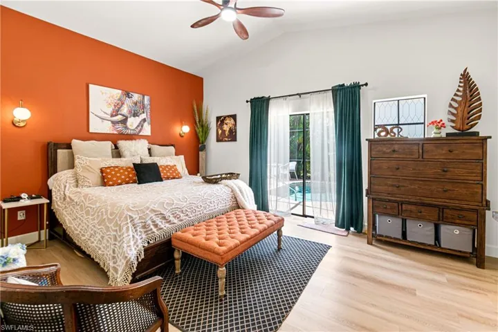 Primary Vaulted ceilings feature a ceiling fan and light-tone wood-finish flooring