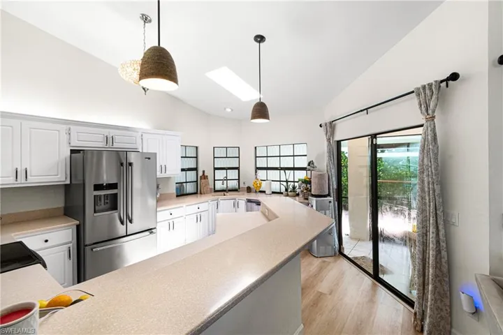 Kitchen featuring white cabinetry, light-toned countertops, and stainless steel appliances