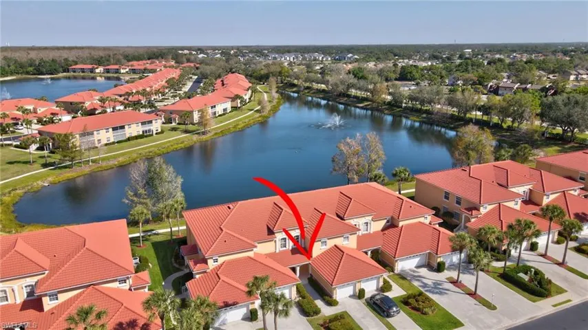 Birds eye view of property featuring a water view and a residential view