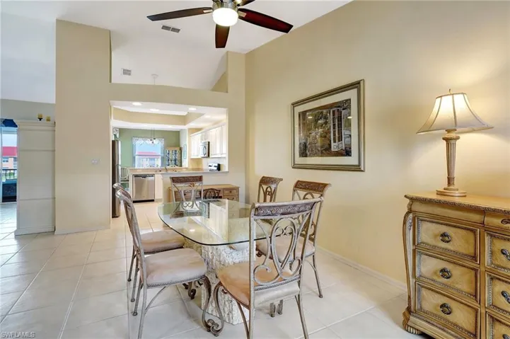Dining space featuring a ceiling fan, visible vents, baseboards, and light tile patterned floors