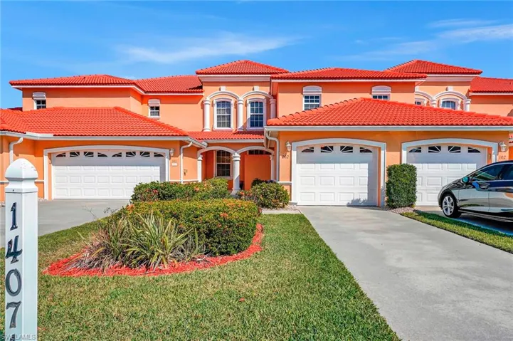 Mediterranean / spanish-style home with a garage, concrete driveway, a tile roof, and stucco siding