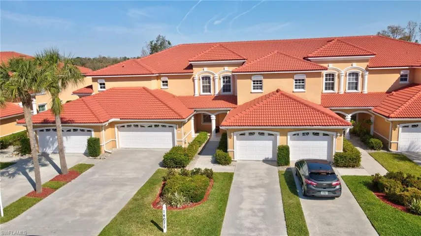 Mediterranean / spanish-style house with a garage, stucco siding, driveway, and a tiled roof