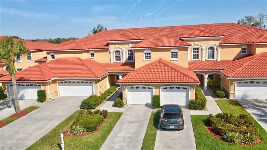 Mediterranean / spanish home featuring an attached garage, driveway, and a tiled roof