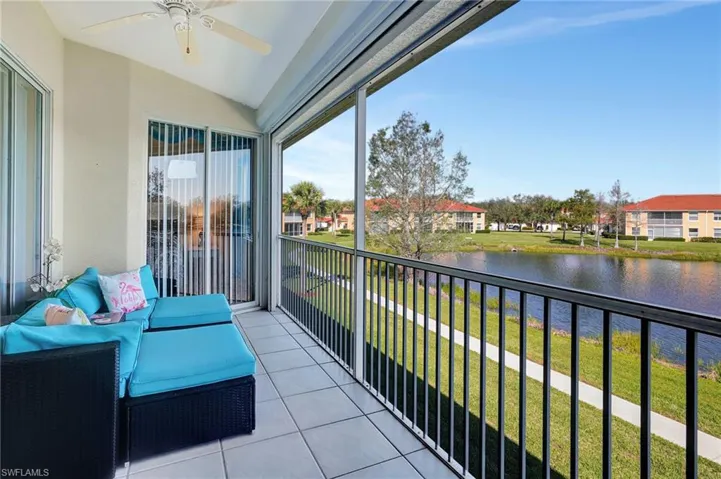 Balcony with a water view and a ceiling fan