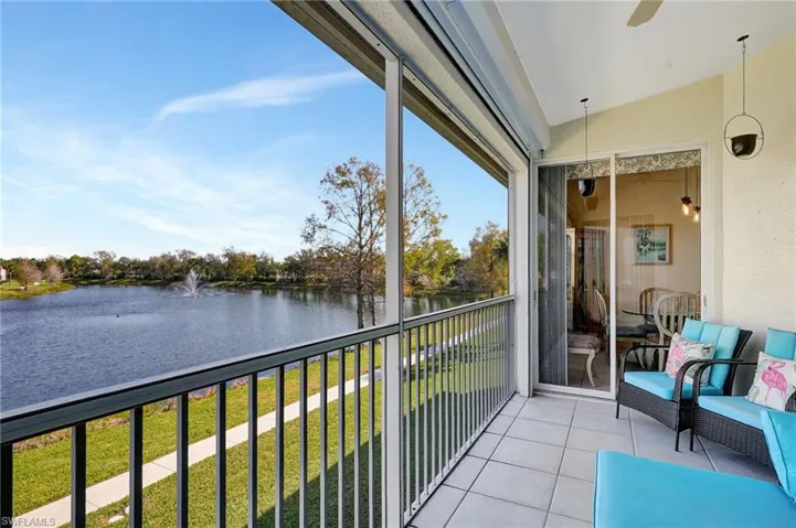 Balcony featuring a water view and a sunroom